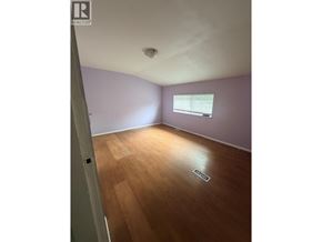 Maple Ridge apartment for rent - A room with a window and wooden floors.
