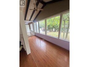 Maple Ridge apartment for rent - A room with wooden floors and a ceiling fan.