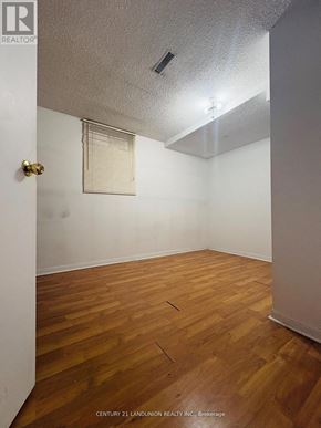 Richmond Hill (Harding) apartment for rent - A room with wooden floors and white walls.