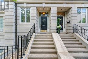 Toronto (Casa Loma) townhouse for rent - A set of stairs leads to a black door with a glass window above it.