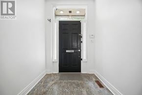 Toronto (Casa Loma) townhouse for rent - A black door is in a white room with a marble floor.