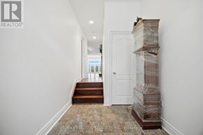Toronto (Casa Loma) townhouse for rent - A hallway with a door and a stack of boxes on the floor.