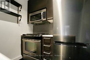 Toronto (South Riverdale) condo for rent - A modern kitchen with stainless steel appliances and a microwave mounted above the stove.