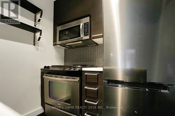 Toronto (South Riverdale) condo for rent - A modern kitchen with stainless steel appliances and a microwave mounted above the stove.