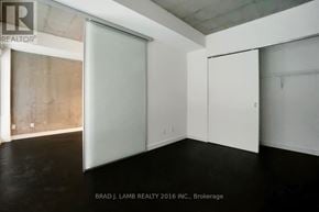Toronto (South Riverdale) condo for rent - A room with a sliding door and a white wall.