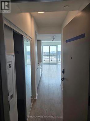 Brampton (Fletcher's Creek South) condo for rent - A hallway with a door on the right and a window on the left.