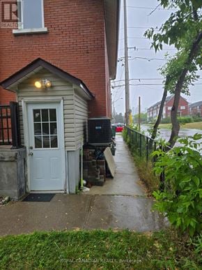 Mississauga (Cooksville) apartment for rent - A small house with a white door and a sign that says "REALTOR" on the window.