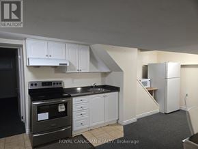 Mississauga (Cooksville) apartment for rent - A kitchen with black appliances and white cabinets.