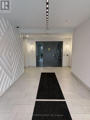 Kitchener condo for rent - A hallway with a black and white patterned wall and a black door.