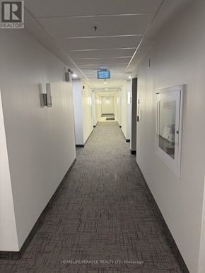 Kitchener condo for rent - A long hallway with a blue light at the end.
