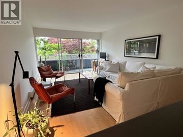 Vancouver apartment for rent - A living room with a white couch and a red chair.