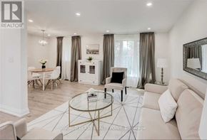Toronto (Don Valley Village) apartment for rent - A living room with a white couch, a coffee table, and a dining table with chairs.