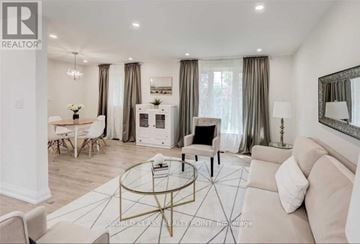 Toronto (Don Valley Village) apartment for rent - A living room with a white couch, a coffee table, and a dining table with chairs.