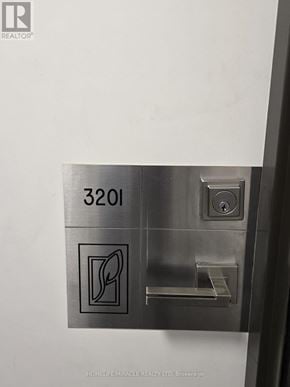 Mississauga (Creditview) condo for rent - A metal plate with the number 3201 and a symbol on it is attached to a wall.