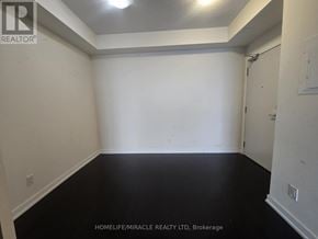 Mississauga (Creditview) condo for rent - A room with white walls and black flooring is shown.
