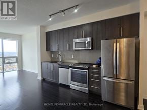 Mississauga (Creditview) condo for rent - A modern kitchen with stainless steel appliances and dark wood flooring.