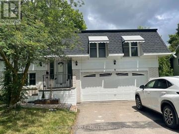 Barrie (Cundles East) apartment for rent - A white house with a black roof and a car parked in front.