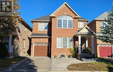 Markham (Wismer) apartment for rent - A large brick house with a garage and a driveway.