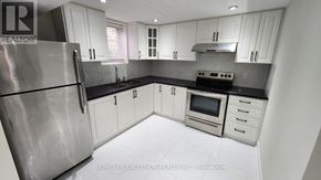 Markham (Wismer) apartment for rent - A kitchen with white cabinets and a stainless steel refrigerator.