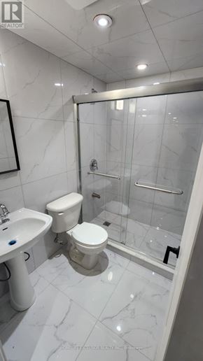 Markham (Wismer) apartment for rent - A white bathroom with a toilet, sink, and shower.