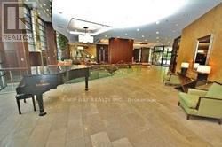 Toronto (Willowdale East) condo for rent - A grand piano is situated in a room with a wooden floor.
