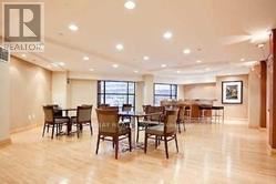 Toronto (Willowdale East) condo for rent - A large, well-lit room with wooden floors and multiple dining tables.