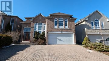 Richmond Hill (Rouge Woods) apartment for rent - A house with a brick facade and a white garage door is for sale.