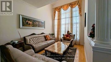 Richmond Hill (Rouge Woods) apartment for rent - A living room with a couch, chair, and a painting of a deer.