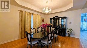 Richmond Hill (Rouge Woods) apartment for rent - A dining room with a chandelier, a table with chairs, and a cabinet.