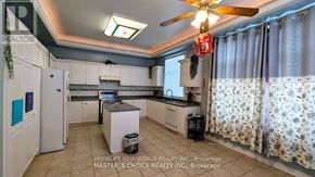 Richmond Hill (Rouge Woods) apartment for rent - A kitchen with a ceiling fan and a fridge.