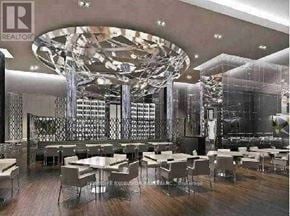 Toronto (Waterfront Communities) condo for rent - A large, modern dining room with a glass table and chairs.