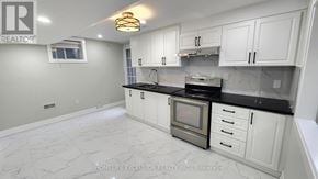 Markham (Greensborough) apartment for rent - A kitchen with white cabinets and a marble floor.