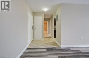 London apartment for rent - A hallway with a rug on the floor and a door on the left.
