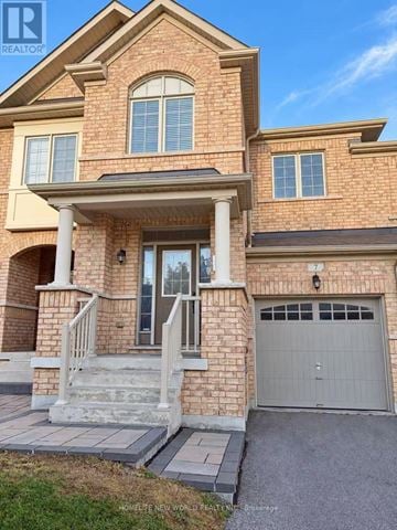 Richmond Hill (Jefferson) townhouse for rent - A two-story brick house with a garage door and a covered front porch.