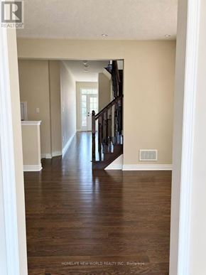 Richmond Hill (Jefferson) townhouse for rent - A long hallway with wood floors and a staircase.