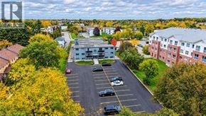 Cambridge apartment for rent - A parking lot with cars and a building in the background.