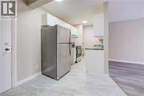 Cambridge apartment for rent - A modern kitchen with a large refrigerator and a marble island.