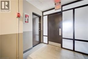 Cambridge apartment for rent - A hallway with a door on the right and a fire extinguisher on the wall.