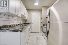 Cambridge apartment for rent - A kitchen with white cabinets and a marble countertop.