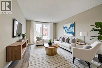 Cambridge apartment for rent - A living room with a white sofa, a wooden table, and a painting on the wall.