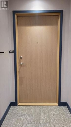 Mississauga (City Centre) condo for rent - A wooden door with a handle and a number 4700 on it.