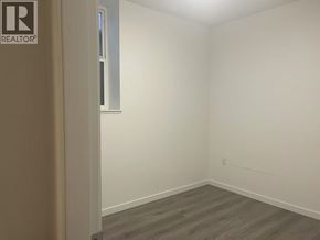 Burnaby apartment for rent - A room with a window and a wooden floor.
