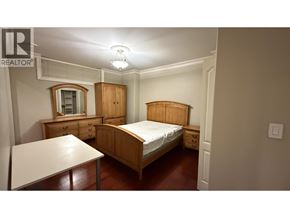 Burnaby apartment for rent - A bedroom with a bed, dresser, and nightstand.