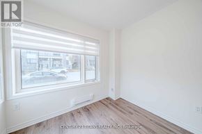 Pickering townhouse for rent - A room with a window and wooden floors.