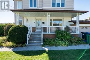 Mississauga (Cooksville) apartment for rent - A house with a white porch and a green trash can in front.