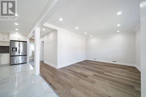 Mississauga (Cooksville) apartment for rent - A spacious room with wooden flooring and white walls.