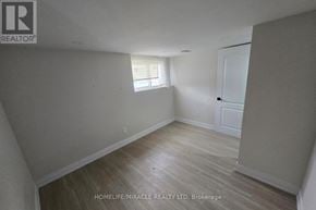 Kitchener duplex for rent - A room with wooden flooring and white walls, with a window on the left side.