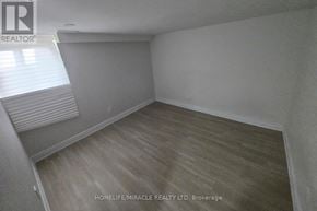 Kitchener duplex for rent - A room with wooden flooring and a window with blinds.