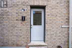 Barrie (Innis-Shore) apartment for rent - A white door with a glass window is on a brick wall.