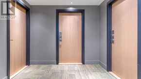 Toronto (Weston-Pellam Park) condo for rent - A hallway with three doors and a carpeted floor.